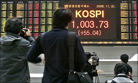 Asian markets mostly lower after US data